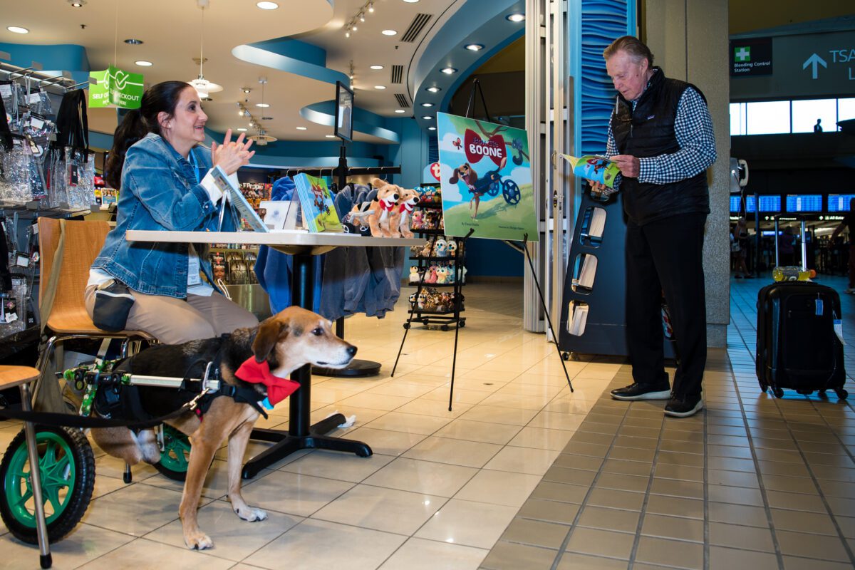 Therapy Dog Boone Signs ‘Paw-tographs’ at Airport